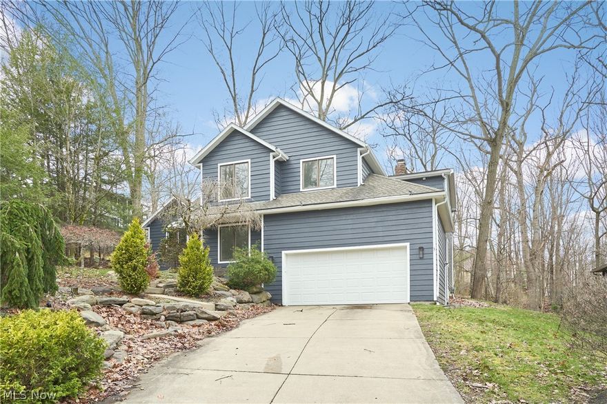Stunning Contemporary with treehouse vibes in Merriman Woods! Fully updated with high-end finishes - absolutely GORGEOUS Bathrooms and Kitchen! This 4 Bedroom, 4 level Contemporary home is nestled on a hillside in the woods with gorgeous views of the wooded ravine. The Kitchen has been fully updated with beautiful quartz and bright white cabinetry, a center island, pantry, and stainless steel appliances. The Living Room has tall, cathedral ceilings and decorative woodwork on the wall, spanning across the formal Dining Room with it's stunning chandeliers that match the huge chandelier in the foyer. The Great Room is over-sized, with hardwood flooring, a fireplace, and sliders to the patio and deck. An Office, Bedroom, and Full Bath are also on this level. Upstairs you will find 2 more bedrooms, another completely updated Full Bath, and the stunning Master Suite. The Master Bedroom has a fireplace and balcony overlooking the rear deck and woods. The Master Bathroom has a large, free-standing shower, double bowl vanity and cabinetry, linen storage, and UPSTAIRS LAUNDRY right next to the WALK-IN CLOSET WITH CLOSET SYSTEM! The Lower Level Family Room is a great space - plus, the basement has been waterproofed! Home has ALL new light fixtures! The hardwood floors have all been refinished and NEW carpet installed along with NEW tile in the Bathrooms. And ALL plumbing fixtures are new! A massive deck is perfect for entertaining and features a ginormous stone fireplace with expanded firebox.