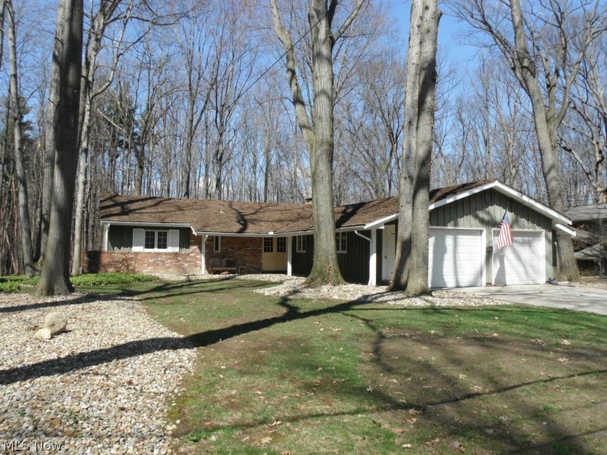 Wooded retreat in desirable Co-Moor! Tucked away on a wooded lot that backs to Metroparks land & located in a quiet, low traffic area of Strongsville! The perfect setting for this ranch-style home w/cedar siding and shake roof! Interior boasts of windows from which to enjoy the ever changing natural landscape! Kitchen features breakfast bar, double-sized pantry & is open to family room; both rooms w/ceramic tile floors. Both living & family rms. offer dining space, beamed ceilings & sliding door access to the rear deck. Living rm  also boast wood burning fireplace& hardwood floors! Bedrooms have wood parquet flooring, bathrooms have ceramic tile floors. Modern updates in the master bath, first floor laundry, partial bsmt. is finished & 2 car garage is oversized.