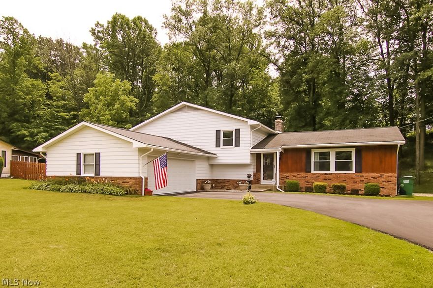 Open and flowing floor plan in this updated split level.  Eat-in kitchen that connects perfectly into the formal dining room with large picture window that floods natural light into the main floor.  With four sizable bedrooms, two and one-half bathrooms, this home is perfect for the growing family or downsizers.  The lower level adds additional living space anchored by a large brick fireplace and entertainment room equipped with wet bar.  The basement has been updated with a new furnace as well as washer and dryer, in addition to extra storage space. Out the main sliding glass doors, you're greeted by the wooded and serene landscape while on your attached deck with built-in seating. Attached two car garage. Great schools. Minutes from shopping, restaurants, and many more amenities.