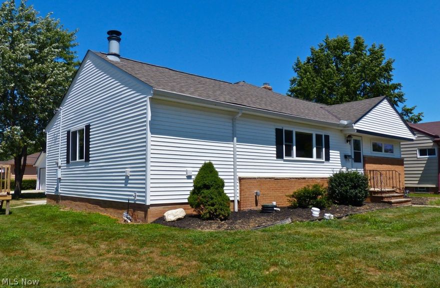 What a great house! Convenient location to shopping, freeway and Manry Park. Open floor plan with large living area Offering a stone WBFP w/gas, spacious eat-in white kitchen with appliances, breakfast bar island and planning desk, step into the very spacious vaulted & beamed family room with laminate floors and walls of windows. Three bedrooms, updated bath, lower level offers a finished rec /family room with wet bar, plus a huge unfinished side of the basement too, glass block windows & full bath, NEW roof in 6/2015, Windows are 3 years old, Professionally installed Backflow Prevention System just installed, New Carpet, Fresh Paint, Newer siding and 20x 20 Two car garage, New Electrical panel, Home also offers Central air, ceiling fans, Humidifier, Patio, easy care vinyl siding. .24 AC lot and 12 month home warranty. The F/R addition foundation has been water proofed and seal coated.