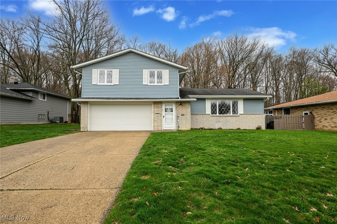 Rare find! Immerse yourself in nature without leaving the suburbs! This spacious split is set on a gorgeous lot which abuts a lush, wooded park, providing privacy and a stunning view! Enjoy a peaceful hike in the woods right from your own backyard! This spacious, welcoming home has an open floor plan perfect for a large or small family, and for entertaining guests. The main level features a large living room with plenty of natural light entering through the big picture window, a separate dining area, eat-in kitchen with newer SS appliances and ample counter and cabinet space. All appliances stay! The main floor bedroom/office with private 1/2 bath is perfect for overnight guests or a remote home office. The upper level offers four generously sized bedrooms with big closets and a full bathroom with dual access from the primary bedroom and hall. Recently refinished hardwood floors flow through the upper level. There’s a big family room on the ground level with a view of the kitchen. An additional half bath is located off the family room. Step outside from the family room and enjoy the screened porch overlooking a peaceful and private wooded backyard, perfect for summer barbecues and gatherings with friends and family. The basement is currently used for storage but could be finished. Recent interior improvements include LVT flooring (main and ground floors), refinished hardwood (upper level), light fixtures and ceiling fans, closet systems, and garage door. The location of this home is simply unbeatable, Indian Creek is a desirable and quiet neighborhood, located just a short drive from shopping, dining, entertainment and freeway. Call for your private showing!