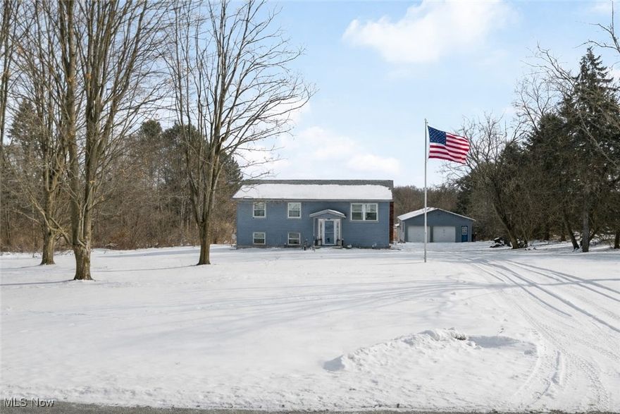 Welcome home to this beautifully remodeled property in Guilford Township, located on one of the most scenic roads in Medina County and within the highly regarded Wadsworth School District. A concrete walkway leads to a covered porch and inviting entry featuring wrought iron railings and a wood accent wall, opening into the main-level living space. The kitchen boasts an eat-in area, a large island with bar seating, quartz countertops, and stylish pendant lighting. The adjoining dining area opens to a sliding door overlooking the backyard and a 14x14 deck with a screened-in porch below. The primary bedroom includes a private full bathroom with a spacious tiled walk-in shower. A second full bathroom is conveniently located off the hallway and features a tub/shower with tile walls. The walk-out lower level offers an additional family room, a fourth bedroom, a full bathroom, and a laundry hookup area with tile flooring and new cement. Outside, you'll find a chicken coop and a large two-car garage with an attached barn offering the potential for three stalls. Numerous updates were completed in 2017, including siding, roof shingles, gutters, downspouts, doors, windows, trim, flooring, lighting, bathrooms, kitchen, concrete areas, garage door, septic system, and well pump. This well-maintained home is ready for your personal touches. Enjoy the country lifestyle with tons of room for animals, four-wheelers and hunting!