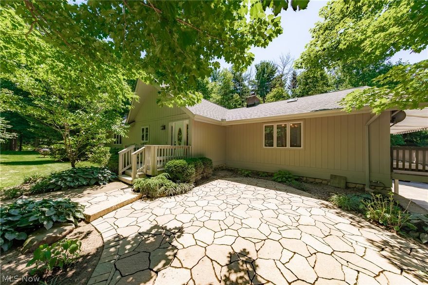 Tucked away on top of a hill, at the end of a winding driveway, you'll find this unique and charming home sitting on a beautiful piece of property that will leave you swooning. Features that make this 3 bedroom ranch with 4 car garage extra special— The large Hearth Style Kitchen with potbelly stove gives you that down-home warm feeling, and it leads to the rear deck. The Master Bedroom with en suite bathroom connects to the sunroom where you'll find a hot tub, just perfect to relax in after a long day. You'll find 3 Fireplaces to keep you comfortable during the cool season, 1 in the great room, 1 in the lower level family room, and the potbelly stove in the kitchen. And, a 4 car garage that's tall enough to park your pickup truck. The yard abuts Red Raider Trails and has easy sloping ravines, a partially fenced area, and storage barn. You'll love enjoying a lazy warm day or gathering with friends on the side patio, rear deck, or front deck…The front deck has SunSetter Awnings and span