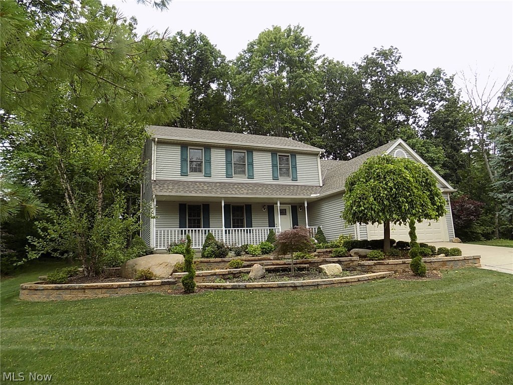 Move-in ready colonial, with full front porch, is located in popular Greenwood Village, a planned community with indoor & outdoor pools, tennis and more! This home is nestled in the woods on a cu-de-sac*Bike trail right in your back yard*Formal living & dining rooms off foyer*Updated kitchen with pantry & sliding door to multilevel deck*Step down family room w/ brick fireplace & two-story vaulted ceiling*Kitchen & family room overlook the private yard*Spacious laundry/mud room & half bath complete the first floor*The two-car garage with newer concrete floor*Upstairs there are 4 bedrooms, including a Master suite w/walk-in closet & newly updated with full bath, oversized tile/shower tub & skylight*Loft was converted to 4th bedroom* Twelve course lower level has been waterproofed (with a transferable warranty) and roughed-in for a bath*Updates include roof 2014, garage floor 2014, hot water tank 2012*Seller has redone first floor*Newer light fixtures throughout, door handles, painting,
