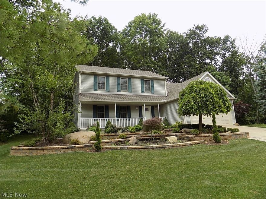 Move-in ready colonial, with full front porch, is located in popular Greenwood Village, a planned community with indoor & outdoor pools, tennis and more!  This home is nestled in the woods on a cu-de-sac*Bike trail right in your back yard*Formal living & dining rooms off foyer*Updated kitchen with pantry & sliding door to multilevel deck*Step down family room w/ brick fireplace & two-story vaulted ceiling*Kitchen & family room overlook the private yard*Spacious laundry/mud room & half bath complete the first floor*The two-car garage with newer concrete floor*Upstairs there are 4 bedrooms, including a Master suite w/walk-in closet  & newly updated with full bath, oversized tile/shower tub & skylight*Loft was converted to 4th bedroom* Twelve course lower level has been waterproofed (with a transferable warranty) and roughed-in for a bath*Updates include roof 2014, garage floor 2014, hot water tank 2012*Seller has redone first floor*Newer light fixtures throughout, door handles, painting,
