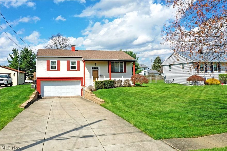 On the hunt for a move-in-ready split-level home with two floors of wonderfully finished living space in a great neighborhood? End your search today with this darling Austintown residence, waiting for you and the summer you’ve been dreaming of! Packing a curb appeal punch, this handsome structure is quick to attract with its bold, red trim and extra wide cement driveway that leads to the lower two car garage; filled with nature stone style flooring and housing workshop space and laundry services. Around the back, a covered and raised rear patio makes for perfect relaxation, all while a bonus storage shed joins in the backyard. Open the front door to a well-lit foyer as carpeted stairs rise to the main level: hardwood under carpet. Here, the illustrious living room takes advantage of the large picture window. Formal dining is just around the corner with instant access to the rear patio. Meanwhile, a central kitchen brings stained wood cabinetry and stainless-steel appliances for an added touch. Down the main hall, a lavish full bath includes an expertly tile tub and shower surround. It all ties into the master bedroom for private access. The remaining two bedrooms bring brightly lit and inviting floor space. Down below, find a wood panel shod rec room that includes a great corner bar for entertaining. A lower half bath rounds things out.