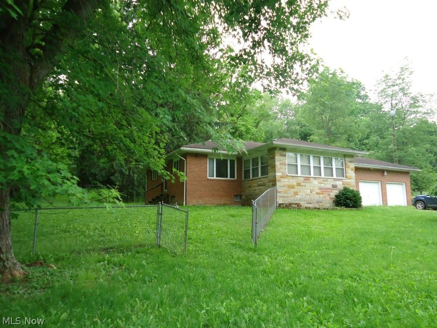 Brick 1 story home on 3.2 acres. 2 bedrooms, kitchen, living room, dining room and full bath. Enclosed breezeway to 2 car garage. Laundry hook up in full bath. Partial chain linked fenced yard. 2 large outbuilding/garages (30x30 and 24x72) with electric. Full basement with unfinished room, toilet and shower.