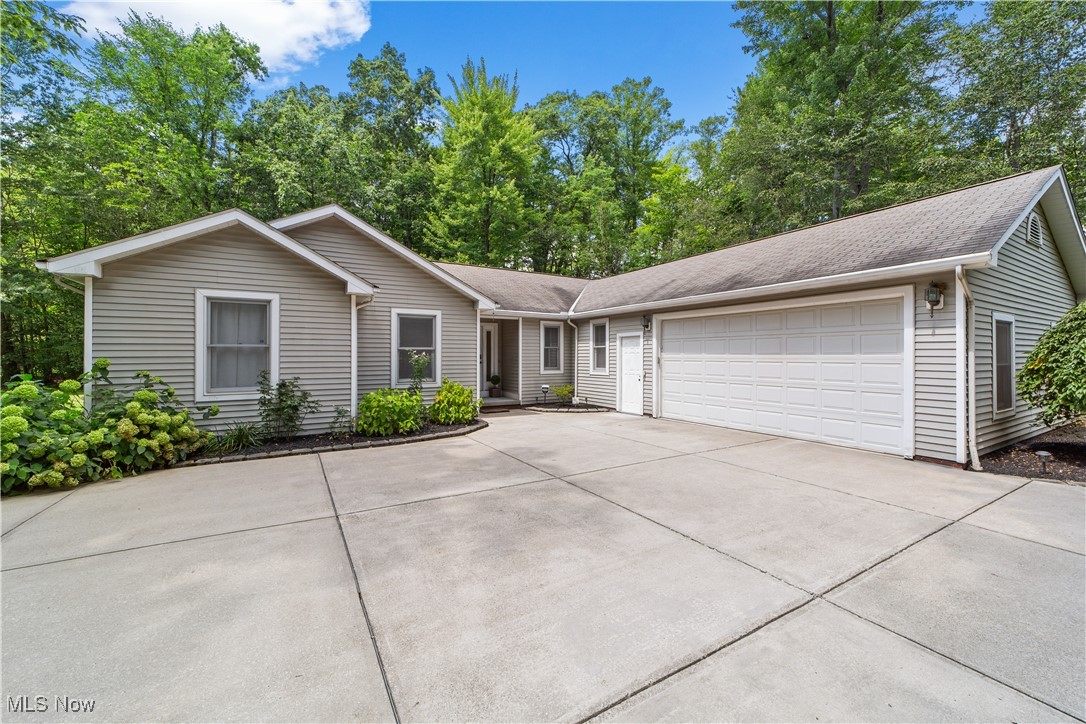 Set back on a private, wooded 1.5-acre lot, this rare 3-bedroom, 2-bathroom ranch offers over 3,000 sq. ft. of living space across the main and fully finished lower level. From the moment you enter, you’ll be welcomed into a stunning great room featuring vaulted ceilings, a striking statement fireplace, and walls of large windows that flood the space with natural light. The open-concept layout flows effortlessly into the dining area, complete with direct access to the expansive, recently refinished wood deck (’25) for the perfect indoor/outdoor living experience. The spacious kitchen is a chef’s dream, offering an abundance of cabinetry, generous counter space, and updated stainless steel appliances (’22), along with fresh paint and flooring (’22). A convenient first-floor laundry room, access to the attached 2-car garage, and a full bathroom are located just off the kitchen. The main level also hosts three well-appointed bedrooms and another full bath with a jetted tub. The primary suite boasts vaulted ceilings and a walk-in closet. Downstairs, the full finished lower level offers endless possibilities—whether you envision a recreation area, home gym, or guest suite- with the added bonus of a second kitchen. Outside, the property’s natural beauty takes center stage with mature trees, a vegetable garden, a large circular driveway, and a sizable storage shed. Updates include a/c ('23), Furnace ('23), electric panel ('25), paint throughout, fixtures, and so much more! All of this in a prime location close to shopping, parks, highway access, and more. Don’t miss the opportunity to own this private oasis in one of the area’s most sought-after school districts!