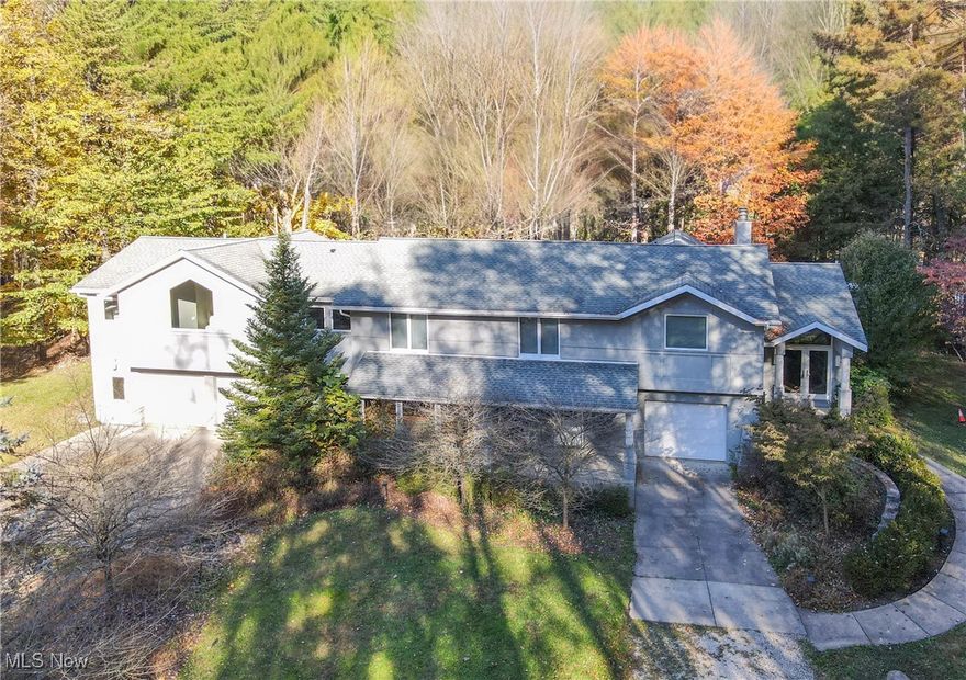 Introducing this breathtaking home, featuring over 3,900 sqft of living space, situated on a 12.26-acre lot in Green LSD. Step through the front door into a welcoming foyer, perfectly positioned at the mid-level of the home. Here, you'll be greeted by large windows in the living area that frame stunning views of the surrounding property. Picture yourself unwinding by the cozy double-sided fireplace, which seamlessly connects the main living area with an additional living space, and provides easy access to the screened-in porch. To explore the upper level, you can choose between the staircase off the foyer or the 1 leading from the main living area. This floor features a modern, fully equipped kitchen with a spacious open dining area. A half wall in the dining space offers a unique perspective, allowing you to enjoy the views through the floor-to-ceiling windows in the living room. Continuing down the hallway, you’ll discover the impressive owner’s suite alongside 3 additional bedrooms, a generous laundry room equipped with a washer and dryer, & 3 full bathrooms. The owner’s suite is a true retreat, complete with 2 walk-in closets & a luxurious bathroom featuring dual vanities, a soaking tub, a walk-in shower, and a linen closet. One of the bedrooms is enhanced with its own ensuite bathroom & walk-in closet. The lower level features its own entrance, a cozy family room, a sunroom, a convenient half bathroom, & a dog kennel with water & drainage. You'll also find ample storage rooms & access to the garages. Step outside from the screened-in porch to a delightful patio complete with a fire pit and deck that overlooks the picturesque property & pond. With a 795-sqft crawl space for additional storage & a 720-sqft carport/shed equipped with electricity, this home offers an abundance of space for vehicles & equipment. The beauty of this property is truly unmatched—don’t miss your chance to make it yours!