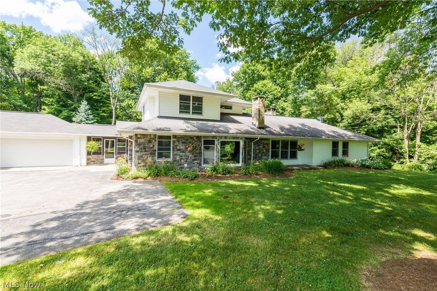 GREAT NEW PRICE!! HOME AND 5 ACRE SCENIC PROPERTY!!  Warm and rustic updated home sitting on the most amazing serene peaceful setting of wooded wonderland!  This home and property are all about the outdoors and will feel like living on your own wildlife preserve and personal forest! House has been updated and transformed from the original ranch while preserving the unique charm and detailed woodwork and character.   From the soaring windows, quiet sun room retreat, patio and deck, to the vaulted great room with stone fireplace, to the wood detailed office w corner fireplace, to the walk out lower level and up to the 2nd floor master suite.  Gourmet kitchen with hardwood floors, newer white appliances, and plenty of counter space.  Opens to the vaulted family room and stone fireplace with barn beam mantle.  3 spacious bedrooms, baths and closets on 1st floor. 2nd floor master retreat with glamour bath and plenty of closet space.  Walk out lower level with 3rd fireplace, stained concrete