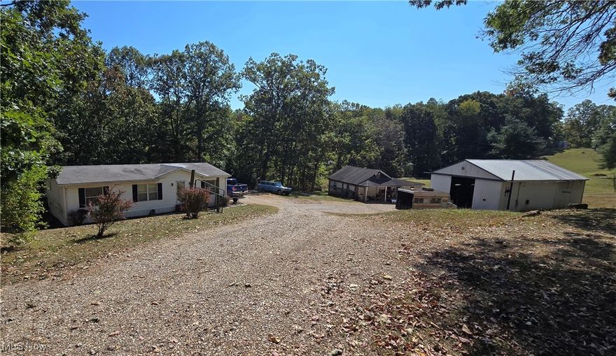 Located just minutes from town, this 1995 model double wide sits on a spacious 1-acre lot with city water and sewer. The home offers a functional layout and basic amenities, though it could use some TLC.

This property also includes a large, detached garage/shop that was previously used for mechanic and auto body work. The shop includes a car lift and has plenty of space for tools, projects, or storage. The shop offers great potential for the right buyer.

Perfect for someone looking for a property with utility and room to grow.