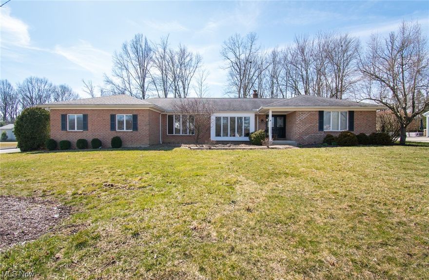 This beautiful brick ranch home sits on a spacious corner lot of over half an acre, just minutes from Canfield High School, and leaves nothing to be desired! Upon entering the foyer, you'll be welcomed into the formal living room and open dining area with a wall of windows and plenty of natural lighting.  Around the corner, you have the perfectly appointed eat-in kitchen boasting custom painted cabinetry and updated appliances, with views of the huge backyard that includes a playset and shed. From the kitchen, you have access to the garage entry, laundry room, half bath and partially finished lower level, where you will find an additional flex space currently used as an office. Enjoy spending time in the bright and open family room featuring a stone surround fireplace, built-in cabinetry and freshly scraped/painted wood beam ceiling. Relax in the bonus room surrounded by nature, with an abundance of windows overlooking the back yard and sliding glass door access to the back porch. As y