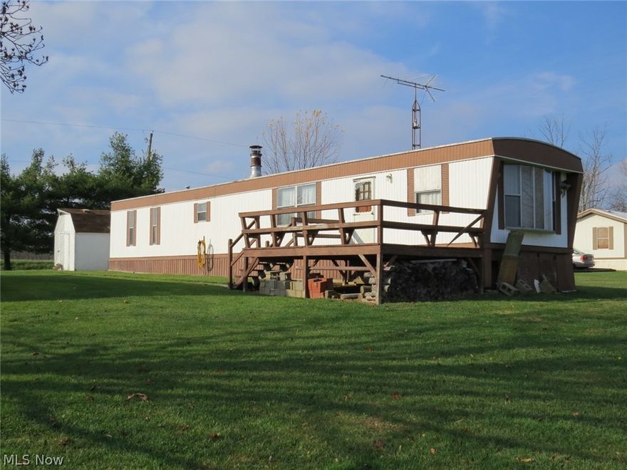 2 Bedroom Mobile Home with 32'x32' Garage! Level, country lot located near public hunting area. Mobile home needs some updating. Large garage with shed addition and storage shed also. Handy location to Carrollton and Canton. Annual taxes without Homestead Reduction and including mobile are $ 327.54      per yr. All minerals owned transfer with property. Property is subject to current gas and oil lease.