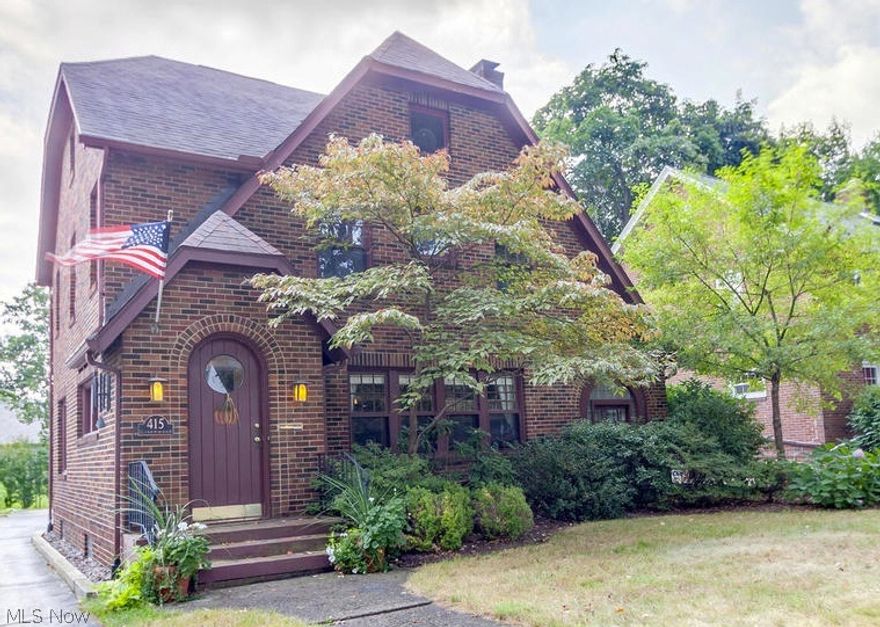 Classic & stately brick colonial on gorgeous tree-lined Greenwood Avenue in charming West Akron.  Interesting architectural lines are the hallmark of this lovely home- the dramatic sloping roof line, beautiful arched doorways & linear stonework around the fireplace all set this home apart.  Cozy family rm, with woodburning fireplace & beautiful hardwoods, is open to dining rm w original built-ins.  Walk thru archway to office/library off of family rm w stylish arched windows.  New kitchen is a showstopper - contemporary meets classic w dark cabinets, butcher block countertops & new wood-look laminate floor -all complimented by silver 'tin' backsplash.  A wall was removed to give kit an extra large feel. Renovated half bath off of kit.  Wide & open staircase w handsome wood detail leads to 2nd flr.  Lrg master BR w new paint & carpet.  2 adtn'l cozy BRs upstairs. Stylishly renovated 2nd flr full bath feat new vanity, sleek black beadboard & Carrara marble floor.   2nd staircase to the 3