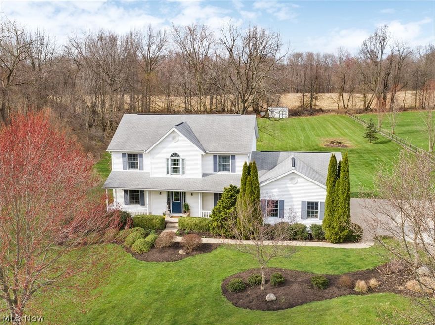 Stunning 4 bedroom, 3 bathroom, colonial sitting on over two acres in Canal Fulton! This beautiful home has been cared for by one owner. Welcome to a completely remodeled main floor with the open concept that is perfect for entertaining! New wood plank flooring and modern fixtures throughout. The eat-in kitchen boasts white, custom Kraftmaid cabinets, including a large pantry, undermount sink overlooking the large backyard, leathered granite countertops with tile backsplash, plus new stainless steel appliances including a built-in 25 bottle wine fridge! A separate living area which open through french doors, a formal dining room, first floor laundry and half bath completes the main floor. 4 generously sized bedrooms upstairs, plus a main bath with double vanities. The master suite has vaulted ceilings, a walk-in closet, and double doors taking you into the bathroom that features a soaker tub and vanity with granite countertops. Sliding glass doors from the kitchen takes you back onto t