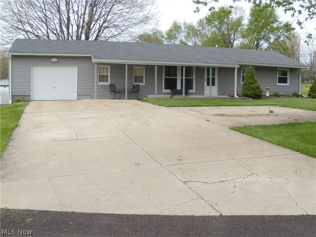 Wonderful updated 3 bedroom 1 bath ranch home on .74 acre in Ravenna Township. Enjoy the outdoors on the covered front porch and rear patio. The family room and enclosed rear porch feature gas fireplaces for chilly days and nights. Fresh paint throughout the home. Updates within the last 2 years include the hot water tank, vinyl flooring, carpet, windows, and the garage door opener. Newer furnace and AC/heat pump 4 years and the roof 6 years. The large 17x10 shed 4 years. New electric service panel spring 2016. The one car attached garage has plenty of room for your car as well as storage on the built in shelves. All appliances stay including the washer and dryer. Public water and sewer. Nothing to do to this exceptional home except move in!