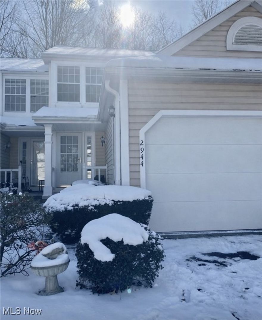 You're sure to enjoy the privacy of the wooded setting in this clean and ready townhome in The Woodlands.  New flooring throughout the open and spacious main floor with stone fireplace and views through the sliding door to fenced in patio and the forest beyond. Enjoy the sights and sounds of nature.  Kitchen could use a little handy work but is clean and functional.  A main floor guest bath can be found just inside the entry foyer.  Upstairs you'll find two bright and spacious bedrooms with the same new flooring, ample closet space and vaulted ceilings.  The primary bedroom directly accesses the full bath as does the hallway.  In the finished lower level you'll find the same new flooring through the rec room which provides a comfortable space to enjoy movies, as a game room, home office, whatever you need.  Another half bath, full size washer and dryer and a cozy utility room complete this level.  Neutral decor and excellent storage throughout.  This great location is close to shopping, dining and all the amenities of Stow. An attached single car garage with additional attic storage and common shared guest parking round out this well priced townhome.  All appliances and rubber garage floor mats remain with home.  New sump pump 2025.  Deck freshly painted fall 2025.  Home warranty included.