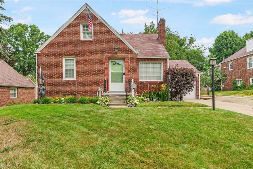 This 3-bedroom, 2-bath brick bungalow is full of charm and thoughtful details that make it feel like home. Tucked away on a quiet street, you'll love the inviting landscaping, long driveway, and timeless brick exterior. Inside, the living room welcomes you with warm oak trim and baseboards, centered around a cozy wood-burning fireplace with a beautiful stone facade. The eat-in kitchen includes a microwave, gas range, dishwasher, and refrigerator, and offers a peaceful view of the private backyard—an outdoor retreat where deer and birds love to visit a thriving blackberry bush. The main floor hosts two comfortable bedrooms, and a full bath that is tastefully updated with a tub/shower combo, tiled surround, built-in shelving, a modern vanity, and built-in storage. Upstairs, a spacious 24x27 area with built-in linen closets and great natural light offers endless possibilities—use it as a primary bedroom, home office, or creative space. The finished basement features a bright rec room, full bathroom, large storage closet, and a laundry area with washer, dryer, and utility sink. There’s also a separate utility room for even more functionality.
Enjoy evenings on the large covered patio overlooking the fully fenced-in backyard. An attached 1-car garage with built-in cabinets rounds out the home’s convenient features. Full of character inside and out, this home is ready to welcome its next chapter.