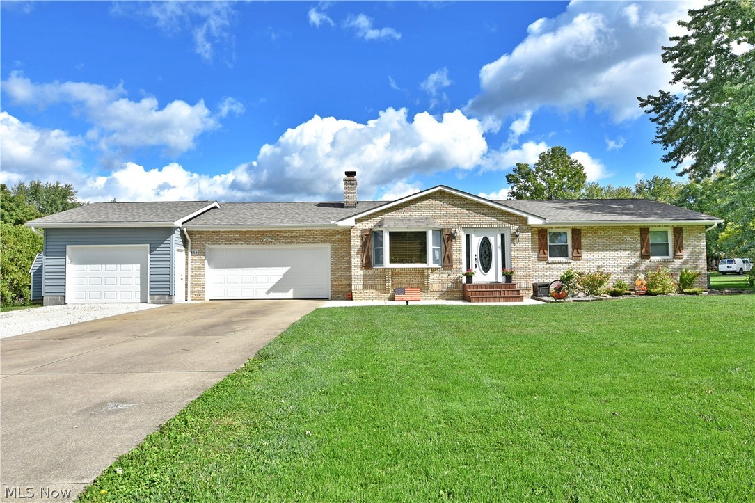 Start your next adventure with this gorgeous 3-bedroom Champion ranch, complete with a fenced in backyard and a stunning pool area! Set in a desirable location on a prominent corner lot, this brick faced beauty immediately grabs your attention with its craftsman style shudders, front steps and an additional attached garage unit for vehicles or equipment storage. Around back, the oasis-like pool is surrounded by a cement pathway before transitioning into a raised wooden patio space. Inside, a bright and inviting living room to welcome you home with warm hardwood flooring and natural light cascading through the elegant entry door and nearby bay window. The illustrious combined kitchen and dining rooms await just across the main hall with tiled flooring, natural wood cabinet and a sun filled eatery that overlooks the backyard. A tastefully updated full bath is first down the hall, as the nearby guest bedroom brings carpeted flooring and cozy quarters. Opposite, the must-see master suite has been expanded to include a decadent private bath with soaking tub and offset shower with vanity. The walk-in closet is found opposite. Down below, a third bedroom with an attached full bath divide basement storage and laundry. There is nothing to do but move in here! Updates include new roof 2019, AC 2019, Furnace 2022, HWT 2021, electric service 200 amp, garage door 2021 and many more! Also offering a home warranty.