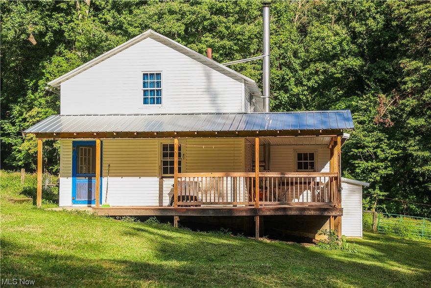 Property to be sold at Onsite Auction: Tuesday, October 10th at 5:00 PM. Located in the northeast corner of Licking County, Ohio, and situated halfway between Martinsburg and Fallsburg on State Route 586, you'll find this 26.9-acre haven. Much of the land is forested, but with adequate clearings that would be ideal for any livestock and there is a small pond to the rear of the property that provides a water source. There's a rustic home with two bedrooms, adorned with a wraparound porch where one can relax and enjoy the simple pleasures of life. While the house doesn't have indoor wiring or plumbing, it is heated with a woodstove. The partial basement houses a root/fruit cellar. And, for your water needs, a hand-pump well stands ready. A small barn with added lean-to and a hay loft rounds out the property's structures. Whether you're looking to lead a quieter, off-grid life or perhaps seeking a recreational or hunting sanctuary, this property beckons your consideration.