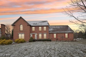 1/2 Acre of professionally landscaped corner lot. The home sets at an angle with curb appeal. Fenced in back yard with a deck, hot tub (6 years old) and pergola. All Brick with a concrete drive into a side entry garage. The garage has high ceilings and has tons of storage. Walk up to this stately home into a spacious entry with spacious rooms. Open Stair case with wide stairs and railings with decorative railings and steps. When coming into the home there is a large Formal Dining Room on the right with hardwood flooring, high ceilings and chair rail. Go to your left and there is a Formal Living Room with High Ceilings and Decorative Glass pocket doors that separates it from the Spacious Family Room. Leave the pocket doors open and you have a wonderful entertaining party floor plan. The Family Room has a masonry fireplace with decorative facia for a mantel and a raised hearth. Transom windows between the Living Room and the Family Room over the pocket doors. French doors from the Family Room to the exterior take you to the deck with a working hot tub (6 yrs new) plus a pergola. Vinyl fenced in back yard. Beautiful wood Anderson widows with screens. Between the Family Room and Eat In Kitchen there is a wet bar/butler panty with built ins and wine glass shelve. The Dinette area is bayed out with floor to ceiling windows, hardwood flooring, high ceiling, loads of cabinets with a new york staggered design. The working island fits 4 barstools with a sink and new dishwasher. New refrigerator with another area of counters and cabinets. No lack of counters in this home. No drop ceiling and open over the cabinets. A real Walk in Pantry and the laundry room is separate with closet and laundry vanity/sink. Master Bd with coffered ceilings Lg walk in and a Bonus Room with 2 sky lights. 90% finished Lower level has high ceilings insulation on on exterior walls. Water softener and Bar.