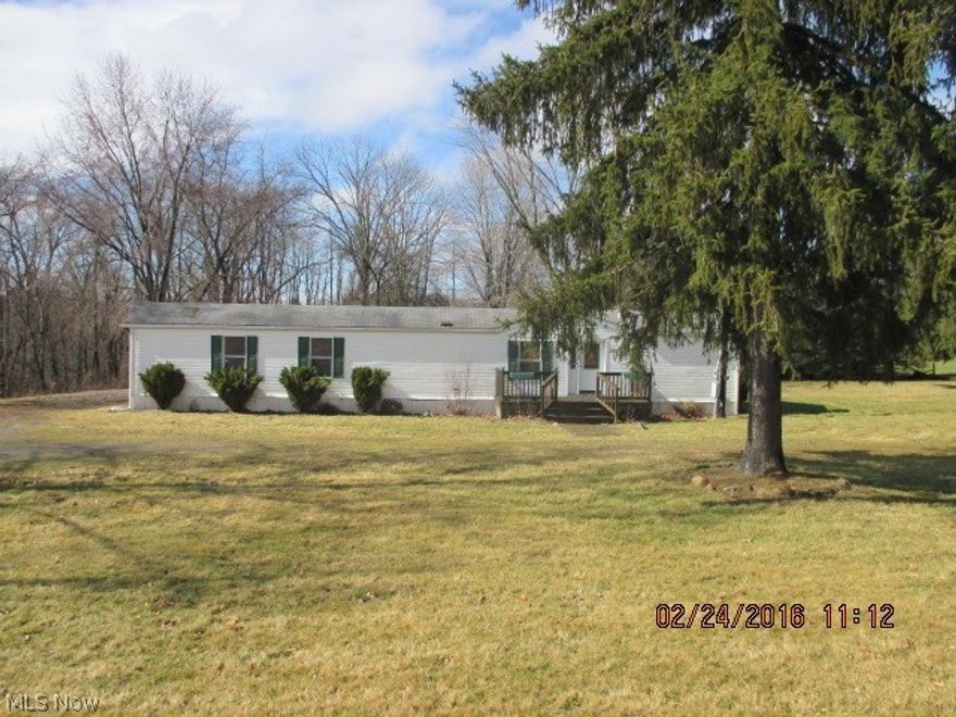 Priced to Sell!! Located on 1.4 acres, this manufactured home features a good sized kitchen with eating area, enclosed area with
washer and dryer, 2 bedrooms and 2 full baths. Front deck, patio in back and also includes a  carport and storage shed.