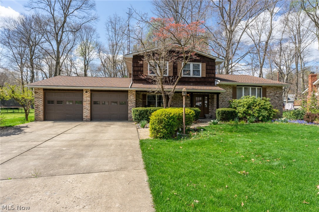 So many great features await you in this custom built four level split. Pride of ownership beams in every part of this well cared for home. It starts when you pull up to the stately brick exterior with cedar accents and a pristine expansive concrete drive. Enter through the foyer which overlooks all the living spaces of the house. Just off the entry is the first floor bedroom, full bath and laundry. The main living area is designed for entertaining with formal dining and living rooms. The kitchen has new stainless steel appliances with plenty of cabinetry and counter space. A gorgeous wood burning fireplace enhances the spacious family room which has an abundance of natural light flowing through from the sliders. Step out into your enclosed patio with wood ceilings and sky lights and then onto a concrete patio overlooking the almost half acre fenced lined lot. The updates include roof, furnace and hot water tank (within 10 years), washer and dryer, kitchen appliances, and kitch