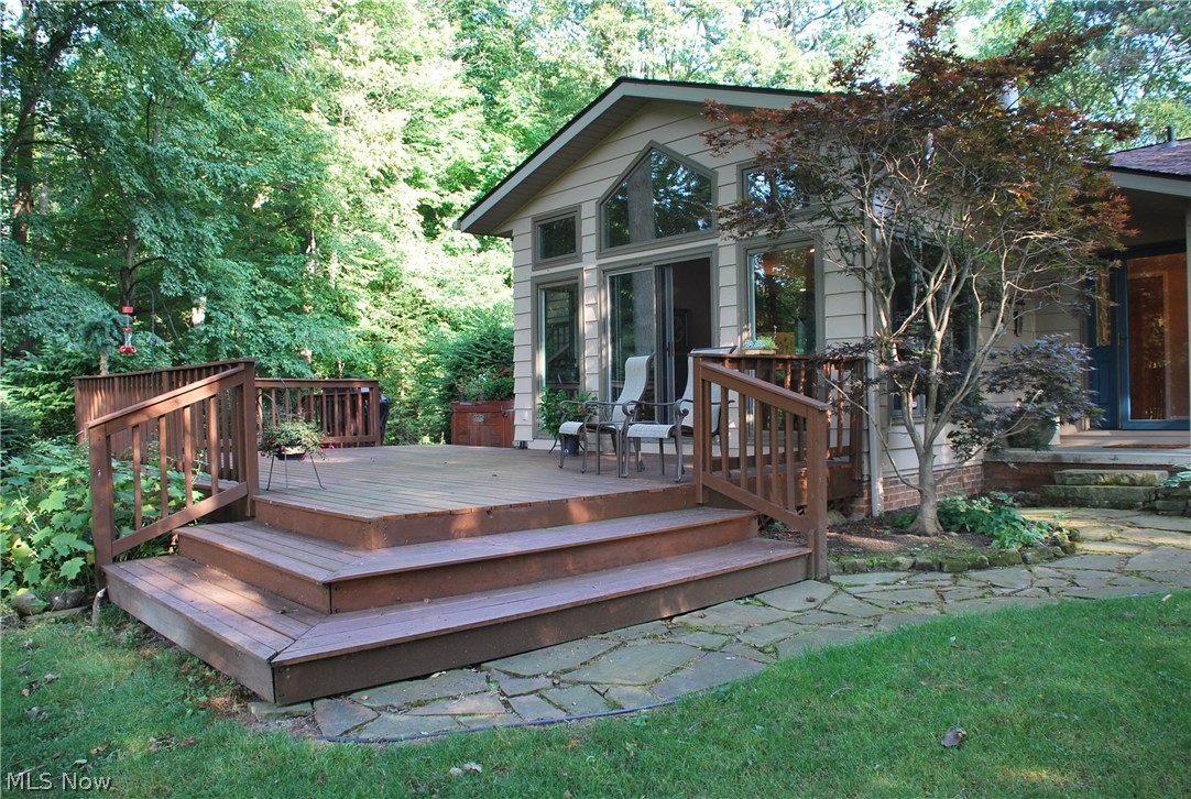 This is TRULY the Home of Your Dreams! Water views from the front & the back of this home with almost 3 acres of land; private & direct lake access with a ton of water frontage, dock/mooring available with a large yard barn tucked in the woods. Relax on the huge back deck over looking the tranquil setting with mature trees, lots of wildlife & birds, plenty of yard & even more woods! This home has 3 levels & a basement for storage & utilities. The 2 car garage is oversized, has a HUGE storage access above it & steps to basement! Main level has both Front Living Room with water views through the numerous windows & back Great Room that is vaulted with the perfect view through the wall of windows of the back yard & water! The custom Kitchen has tall cabinetry & a great layout for cooking as well as entertainment with the eating bar separating the Dining Area. This open concept lends itself to a great flow for both family & entertaining! There are numerous doors to the exterior & the deck