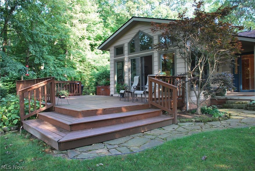 This is TRULY the Home of Your Dreams! Water views from the front & the back of this home with almost 3 acres of land; private & direct lake access with a ton of water frontage, dock/mooring available with a large yard barn tucked in the woods. Relax on the huge back deck over looking the tranquil setting with mature trees, lots of wildlife & birds, plenty of yard & even more woods! This home has 3 levels & a basement for storage & utilities. The 2 car garage is oversized, has a HUGE storage access above it & steps to basement! Main level has both  Front Living Room with water views through the numerous windows & back Great Room that is vaulted with the perfect view through the wall of windows of the back yard & water! The custom Kitchen has tall cabinetry & a great layout for cooking as well as entertainment with the eating bar separating the Dining Area. This open concept lends itself to a great flow for both family & entertaining! There are numerous doors to the exterior & the deck