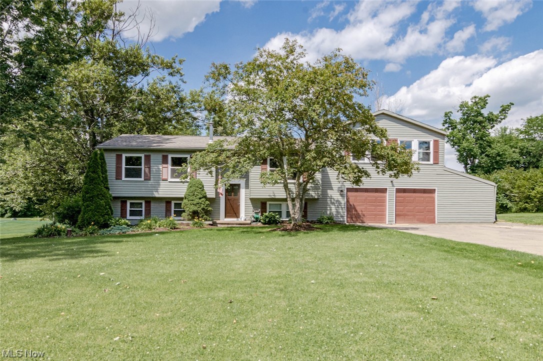 Great opportunity for a spacious bi-level home on a tranquil 1.5 acre lot in Auburn! This welcoming home features 4 bedrooms, 2 full bathrooms, spacious open living areas, several recent updates, and an expansive yard. All it needs are your personal touches! The front door opens into the stairway that ascends to the open-plan kitchen and dining room. Here you will find a full complement of appliances, plenty of cabinet space, a sliding door to the back deck, and updated LVT flooring. Off of the kitchen there is a very spacious rec room above the garage that functions well as a playroom and home gym. On the other side of the upper floor is a sun-filled living room, a large bedroom, and a full bathroom. The lower level features 3 bedrooms including the primary suite. Here you will find a generous bedroom, a walk-in closet, an office that could also be a nursery, and access to an updated full bath with a double-sink vanity. A wood stove at the base of the stairs and a laundry / utility room complete the lower level. Additional recent updates includes LVT flooring throughout the lower level, a new roof in 2020, and a new Trane furnace and AC in 2015. Conveniently located just a stone's throw from Kenston schools and just minutes away from highway access and shops. Don't miss this one - it will go fast!