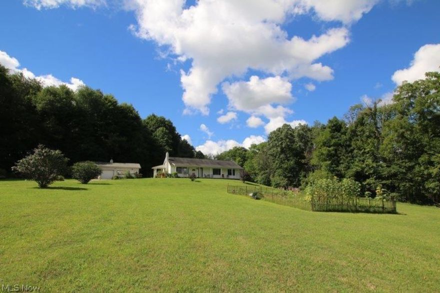 WOW! What a picturesque setting in eastern Knox County! 64+ acres of rolling woodlands, pastures, tillable farm fields, & small stream. Over 2,000+ ft of road frontage- GREAT INVESTMENT! The property has a little bit of everything for every outdoor enthusiast: great whitetail, turkey, rabbit, & squirrel hunting; ATV & horseback riding; hiking trails, farming & livestock opportunities! Ranch home sits 900' off road w/ tons of privacy! The home features a 50' long covered front porch, a covered side porch opening to the utility rm, and a LL covered porch protecting the glass patio doors of the walk-out basement. Floor plan consists of a front living room, spacious eat-in kitchen, large utility rm, full hall bath, 3 bedrooms, & master bath. Full poured-wall basement. 24'x40' detached garage.