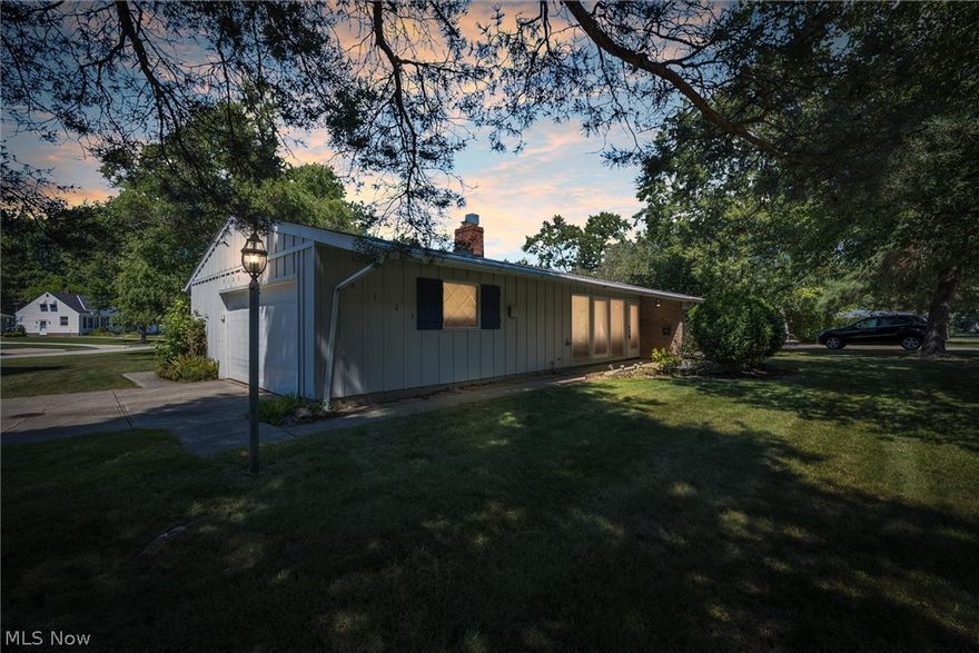 The perfect solution for one floor living is at your fingertips with this mid-century ranch in Lyndhurst. Located on a quiet tree-lined street, this corner lot home boasts soaring ceilings and an open floor plan. A breezy galley kitchen looks out into the rest of the home for easy entertaining, off the kitchen is a spacious mudroom/bonus space. Neutral décor throughout with tons of storage options and flexible layout. Down the hall you'll find 3 spacious bedrooms, an ensuite primary bedroom, and another full bath, all with good closet space. A large fenced in yard with patio will be the place to host barbecues and events, with lots of room left for your garden and a perfect shady spot under the weeping willow for an afternoon snooze. 2 car garage has naturestone flooring and home had a roof replacement in 2015. Come bring your finishing touches and make this charmer yours today.