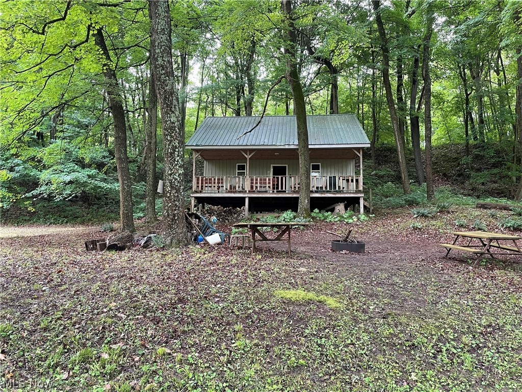 A hunter's oasis! Come check out this remote water front cabin surrounded by AEP hunting ground. This secluded cabin is equipped with wood burning fireplace and wired with 120 amp service that can run by a generator or 12 volt battery can be used to provide lighting. Grill out on the covered porch or roast marshmallows by the campfire all while fishing waterfront Wills Creek. This cabin has an open concept main floor with a loft area that can accommodate multiple beds. Bring your family for a weekend unplugged!