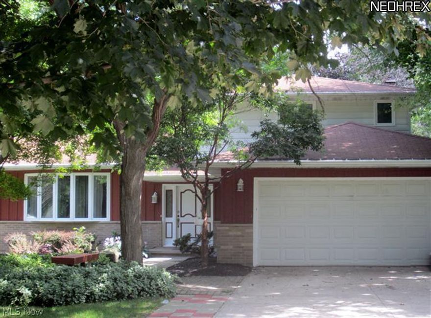 Spacious Split Level Home offers 4 large bedrooms and 2.5 baths. Recently updated kitchen includes appliances, large island with breakfast bar, eat-in area and laminate floor with hardwood look. Family room has brick fireplace surrounded by built-in bookshelves and sliding door that opens to the backyard patio. 4th bedroom on first floor could be den. Basement has finished rec rom, play area, second laundry room with workshop that includes pegboard lined walls. Beautiful treed yard with deck and large patio with built-in benches. Don't miss this opportunity!