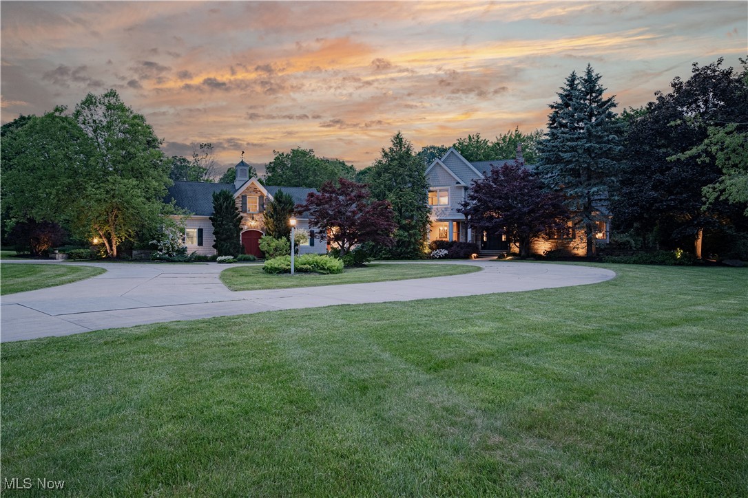 A Private Paradise on Over 13 Glorious Acres – Welcome to a breathtaking estate where timeless elegance meets the tranquility of nature. This sanctuary offers a rare blend of seclusion and sophistication. A sweeping circular drive leads to a gracious entry, where arched ceilings and gleaming cherry hardwood floors flow throughout the main level. Step into the soaring living room, where vaulted ceilings with exposed beams, a floor-to-ceiling stone fireplace, and a statement chandelier create an atmosphere of warmth and grandeur. A large picture window fills the space with natural light, creating a welcoming ambiance. The formal dining room, framed by a bay window, exudes charm and grace. The chef’s kitchen dazzles with granite countertops, a center island, walk-in pantry, and a sunlit dining nook with sliding doors to the expansive patio—seamlessly blending indoor and outdoor living. The first-floor primary suite is a peaceful retreat, complete with vaulted ceilings, dual walk-in closets, and a spa-like ensuite with mosaic tile floors, soaking tub, dual vanities, and a step-in shower. A private sitting room/library opens to a secluded patio for added serenity. A two-story family room is flooded with light and features a cozy wood stove and a dramatic wrought-iron cage chandelier. A private suite upstairs includes a full bath and walk-in closet. Three additional bedrooms showcase unique architectural details—two connected by a Jack-and-Jill bath—plus another full bath on this level. The finished lower level offers a spacious rec room, kitchenette, and another full bath, ideal for entertaining or extended stays. Tucked away in the woods, a private guest cabin elevates the estate with a full kitchen, screened porch, expansive rec room, multiple baths, and a 2-car garage. Whether you’re unwinding beside the tranquil pond, gathering fruit from your own orchard, or simply savoring the serenity, this exceptional estate is more than a home—it’s your personal paradise.