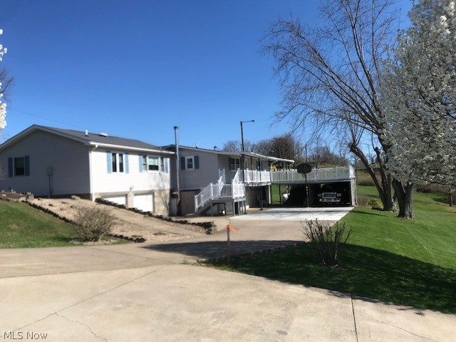 Located on 1 country acre you will love this beautiful move-in condition ranch style home. From the minute you walk in the front door you'll see the pride in ownership. The original home was built in 1964 but then added on to and remodeled in 2007. You will love the HUGE great room and the large bathroom was the new addition. The kitchen is so spacious complete with beautiful quartz countertops and stainless steel appliances. Sit on the huge rear deck ( vinyl railing) and enjoy a park-like setting. There is also a large covered front porch. There are two furnaces, two woodchuck wood burners, two AC units, and two hot water tanks. This seller used the wood stoves a lot to heat with. The house has 3 integral garages and two carports under the deck. The septic will be pumped and checked. Located just 1.8 miles from I-70. You are 10 min. to St. Clairsville and 20 min. to Wheeling. Nice house at a nice price!