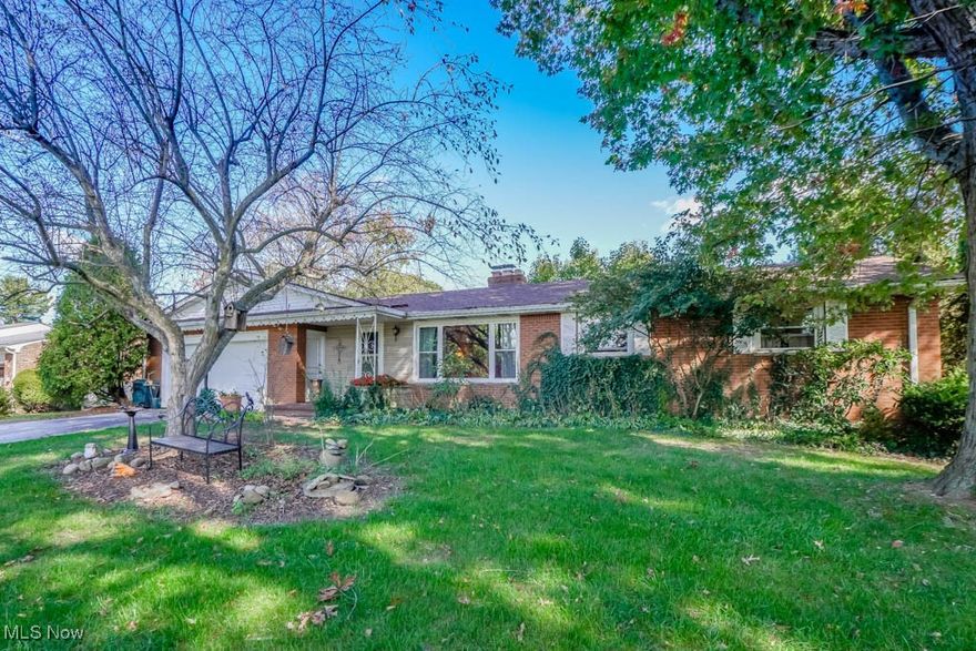 Step inside this inviting 3-bedroom, 1.5-bath ranch offering over 2,000 sq. ft. of comfortable living space. The bright living room features a large picture window and a cozy fireplace with mantel. A nearby dinette area makes the perfect breakfast nook, while the galley kitchen provides plenty of cabinet space and opens to the formal dining room with built-in shelves and access to the covered back patio—ideal for entertaining or enjoying peaceful views of the spacious lot. Down the hall are three bedrooms with beautiful hardwood floors, including one with a private half bath. The lower level extends your living space with another fireplace, paneled walls, separate laundry room and abundant storage. Wonderful location close to parks, grocery stores, shopping, restaurants and more! Call to schedule a showing!