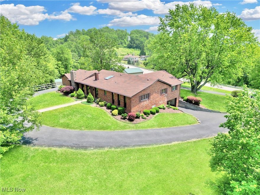 Welcome to this exquisite brick ranch gracefully perched atop a gentle hill, on nearly a full acre of picturesque surroundings. From its timeless exterior to its thoughtfully designed interior, this three-bedroom home exudes both warmth and sophistication.
Inside, you’ll discover a spacious, light-filled floor plan with three generously sized bedrooms — two of which feature their own private en-suite baths — creating a comfortable, private sanctuary for family and guests alike. The sunken living room is the heart of the home, showcasing a custom-crafted fireplace that draws the eye and invites you to unwind in style. Oversized windows bathe the space in incredible natural light while framing the sweeping views that stretch across your tranquil landscape.Tucked away yet close to all local amenities, this stunning property is a rare find that offers privacy, elegance, and charm. Don’t miss the chance to make this remarkable brick ranch your forever home!