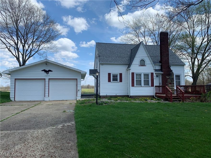 Updated and charming 3 bedroom cape cod with oversized 2 car garage and amazing backyard view! Besides the New Roof, this home features large living room with gas fireplace and gorgeous new hardwood floor, first floor bedroom, completely renovated full bath, amazing new oak staircase up to 2 additional bedrooms, and new vinyl flooring in dining room and kitchen.  Other updates include newer furnace, a/c, hwt, electric box, glass block windows, vinyl replacement windows, light fixtures(LED), exterior steel doors, garage door opener, plumbing for kitchen and bath, gas lines for stove, hwt, furnace, dryer, and fireplace! Relax outside on the front deck, side porch, or back paver patio overlooking acres of fields!
