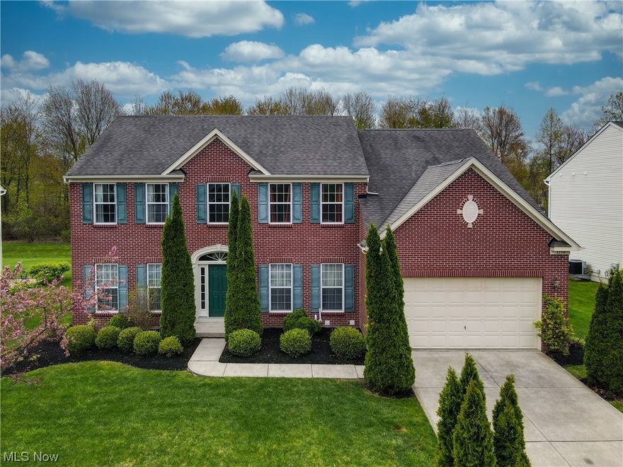 Welcome to this brick and vinyl colonial in Kensington Reserve which is in Twinsburg Township, which benefits from lower local taxes!!! The inviting two story foyer with hardwood flooring opens to the private office with French doors.The formal living room and dining room are tandem to each other, perfect for entertaining family and friends. The heart of the home is the well equipped chef's kitchen with stainless steel appliances, granite counters, center island, ample cabinetry and casual dining area with sliding glass door to stamped concrete patio and lovely landscaped yard! Steps away, the comfortable family room has neutral carpeting and a ceiling fan. There is a convenient powder room on the first floor. All bedrooms are on the second floor with the spacious master suite that has generous closet space and a luxury bath. Three additional bedrooms share the hall bath. The finished lower level includes a theatre room with engineered flooring, a recreation room with carpeting and a t