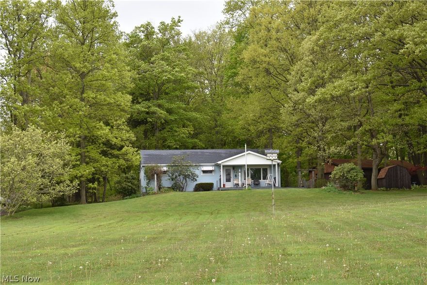 Solid ranch home overlooking 5+ acres on a park-like lot with wooded views. Well maintained & move in ready; just waiting for you! This property offers a 24x40 garage, an 8x10 storage shed, plenty of parking with an outdoor electrical hookup, and a clubhouse with front porch & loft. Abundant storage for all your toys! Features include 3 bedrooms, 1 1/2 baths on the main level, over 1800 sq ft of space, plus a partially finished basement with additional bathroom, storage area, rec room, and the attached garage. Eat in kitchen comes complete with a  2-tier breakfast bar and is open to the family room and bonus Florida Room! The formal living room overlooks an expansive front yard with wrap around driveway. The home sits back approximately 425 ft from the road for added privacy. Located within close proximity to highway access, Gateway schools, (about 2.5 miles), and the Conneaut Creek!