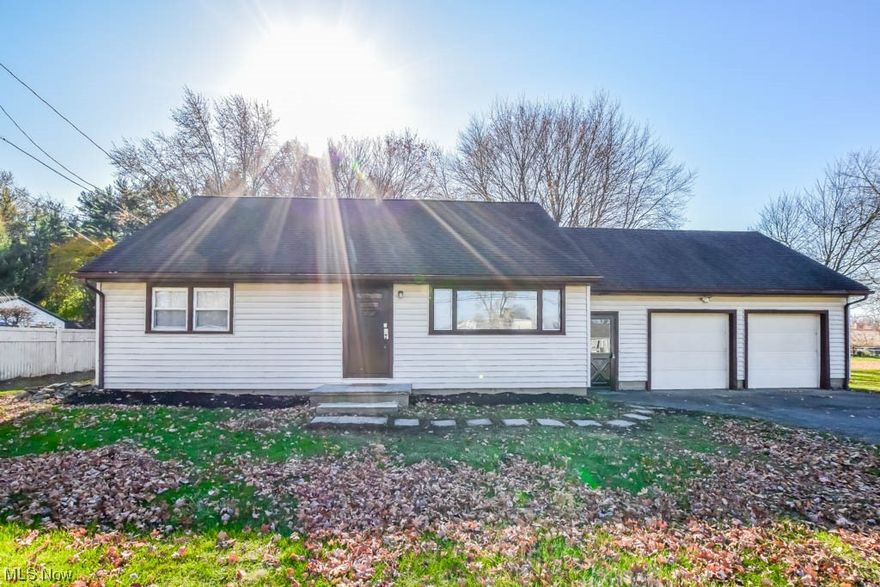 Move right in and enjoy all the updates in this Lake Twp. gem situated on a beautiful treed half acre lot! The perfectly sized interior features new laminate flooring in the living room, which gets tons of natural light from the large picture window. You'll love the renovated kitchen with its pretty wood cabinetry, tiled backsplash, stainless steel appliances, and view of the parklike backyard with a shed. A breezeway adds a convenient drop spot when entering from the attached two-car garage. The classic floor plan offers two first-floor bedrooms and a modern full bath with a tub and shower. Upstairs there's another spacious bedroom with an en suite half bath. All three bedrooms have brand new carpet, padding, and ceiling fans. Other notable improvements include fresh paint throughout, upgraded 200 amp electric with a new external line and ground, water heater, light fixtures, blinds, doorknobs, and faucets. All of this and North Canton schools! Call to schedule your tour today!