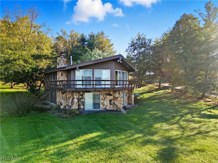 Calling all who’s ever wanted to have a lakefront home. And still have a piece of quietness without being in downtown hassle. This Stone home is absolutely gorgeous. The two story fireplace is designed for family gatherings in large family area or enjoy it upstairs as you prepare dinner at the kitchen. The wraparound sliding glass doors holds so much beauty of fresh sunlight, and the lake.  High ceilings with wood beams, Bring this  A frame look over two very large bedrooms.  Outside holds a matching shed for all of your fishing and boating accessories. So let’s launch across the street you can place your kayaks or just cast one out for the day. The marina is just down the road for you to launch the big boats. Take a look at this home and do it at sunset. The beauty is priceless.