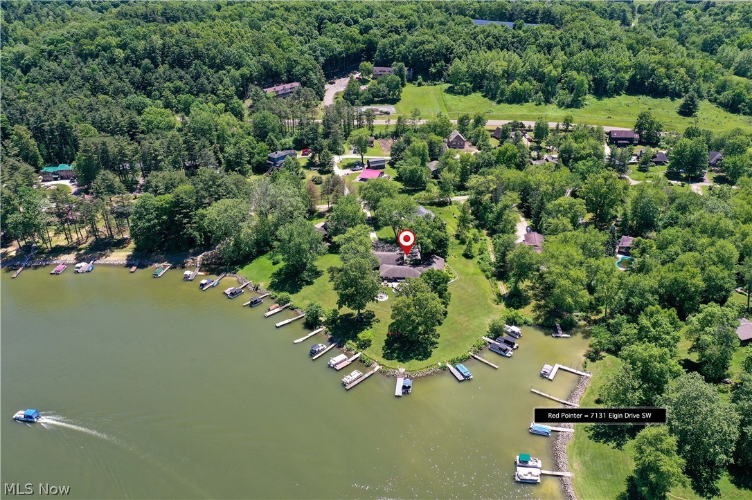 7131 Elgin Dr SW, Sherrodsville, OH 44675 at Atwood Lake in Carroll County with Million Dollar Views is a RARE OPPORTUNITY to live Lakefront with absolutely stunning views & one of the BEST settings with the gorgeous sunsets on the lake! This Ranch Lake Home is one floor living at its finest, great for multigenerational use with up to 5 bedrooms currently one is used as an office w/ lake views, could easily be an in law suite with kitchenette in the attached garage with its own furnace & another large bunk bedroom w/ huge exercise room previously, even has its own sink, 3 full bathrooms (2 standup showers & the master has a corner newer jetted tub with shower head too), 4 car garage (currently housing lots of water sports & large board games like pool & table tennis), huge workshop storage shed with double doors on one end & ramp for mower on the other with plenty of tool storage & workshop spaces, also has plenty of concrete driveway for your toys & guests, huge deck with several seat