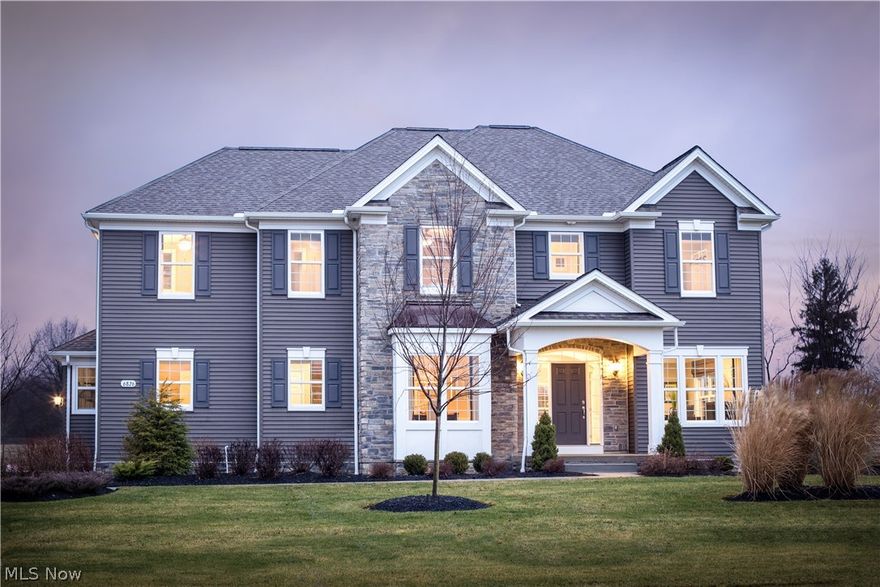 Gorgeous Model Home for sale in popular River Oaks in Hudson!  This stunning home has all the bells and whistles w/ custom paint, enhanced landscaping package w/ outdoor lighting & low-maintenance deck. The 1st floor welcomes you w/ a 2 story foyer, custom staircase with wrought iron railings, formal dining room and oversized home office complete w/ wet bar.   The great room has an open flow to the kitchen with wide-plank flooring that carries throughout and a stone to ceiling gas fireplace. The gourmet kitchen features a huge granite island with additional storage and open shelving, built-in double ovens, 5 burner gas cooktop, tile backsplash and spacious walk-in pantry that offers plenty of storage. The Pulte Planning center off the cafe is the perfect spot for keeping the family organized. Off the 3-car garage, you'll find an oversized mudroom with with built-in bench, storage closet and large laundry room with cabinetry.  A 2nd staircase from the rear entry leads you up to the 2nd