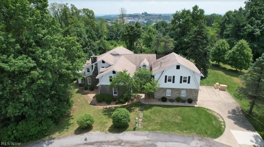 Private 1.68 acre setting in sought after Spring Park neighborhood.  This home has not only original history 1900+ features but also new addition in 1995 on right side of home. Welcoming entry foyer leads to the stunning great room with beamed and beaded board cathedral ceilings, stone fireplace and Palladian windows. A spacious open loft overlooks the great room.  Updated kitchen has eat at counter, granite counter tops and stainless appliances. A cozy living room has a decorative fireplace with stone mantel, nice size dining room, original library with built-ins, beautiful stone floor, bowed windows and glass door.  There are 3 bedrooms and 2.5 baths on this side of the home. An amazing studio/laundry/office with a separate outside entry off the front of the home. The foyer also leads to a separate staircase with additional 2 bedrooms, Jack/Jill suite which could be office/exercise, mother-in law suite or make this into your Master with dressing room and full bath between rooms. The