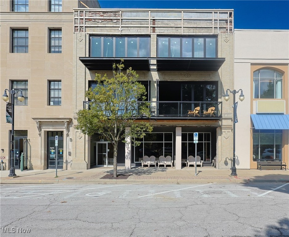 Be one of the first to own a stunning, brand-new condo in the heart of downtown Sandusky, just blocks from Lake Erie. This 2-bedroom, 2-bath home was thoughtfully constructed out of a historic building and showcases soaring 12-foot ceilings, refinished hardwood floors throughout, exposed brick accents, and folding glass doors that open to a balcony overlooking beautiful Sandusky Park. The open-concept living space is filled with natural light and designed for both comfort and style. The kitchen will be installed within 6-8 weeks of an accepted contract, and buyers will have the opportunity to personalize the space by choosing from a curated selection of cabinet and countertop finishes. Additional highlights include in-unit laundry and beautifully finished bathrooms. Offering the perfect combination of historic character and modern elegance, this condo is located across from the park and just steps away from dining, shopping, and the Lake Erie waterfront.