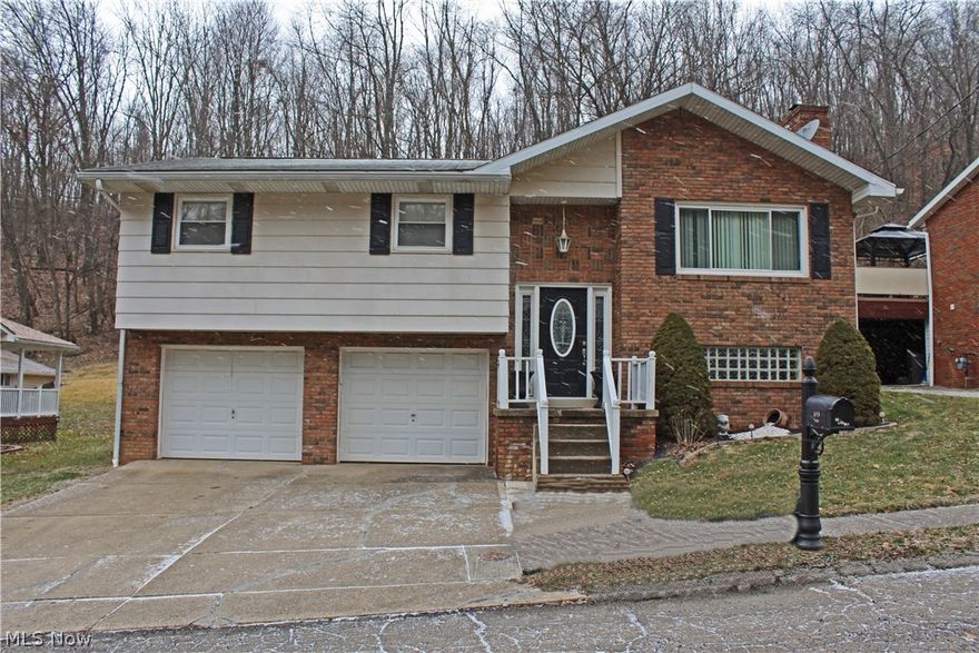 Welcome Home...to this lovely split entry home with brick exterior.  Enjoy cooking in the cherry kitchen with porcelain tile floor and stainless appliances. The dining area also has porcelain floor and French doors that lead to the rear deck.  The bathroom has a ceramic floor and updated fixtures with a private door to the master bedroom. Updated laminate flooring in living room and stairs. Carpet has been updated throughout. Enjoy entertaining in the Recreation Room with fireplace.  Make an appointment to see this one today!