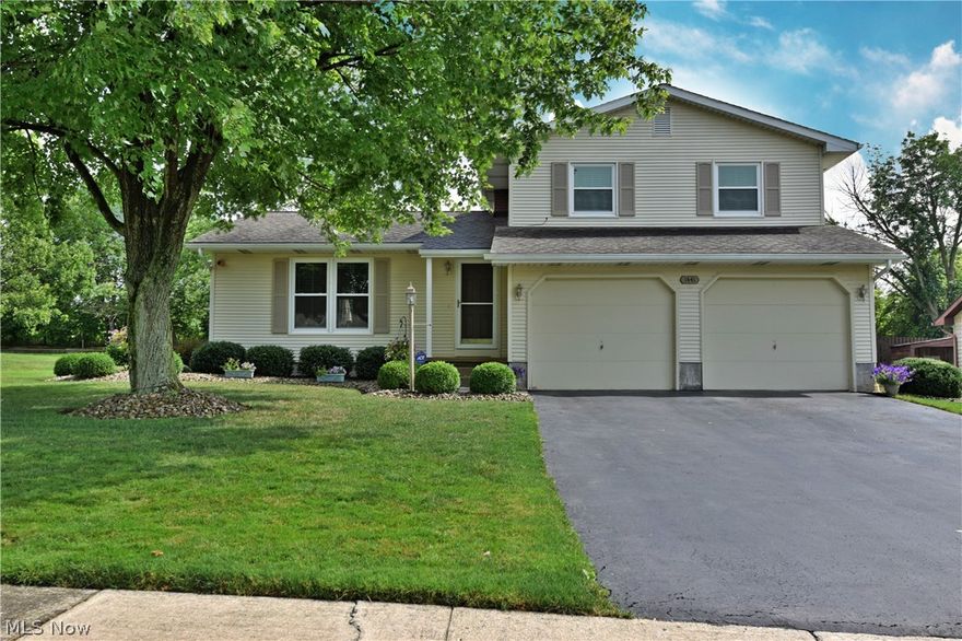A lovely split-level home located in a quiet, residential neighborhood; this charmer is sure to please. Great exterior looks and a large tree casting a relaxing shade draw you closer, as tasteful landscaping wraps around the covered front patio and down the side of the home. Inside, a relaxing living room welcomes you with soft colors and lush, cream carpets. A tiled landing creates a walkway towards the kitchen, where a bevy of warm wooden cabinets wrap the walls above the marbled pattern countertops. Stainless appliances add to the ambiance. A purposeful serving bar extends from counter space making great use of the center wall. Formal dining awaits nearby, complete with rear patio access. The lower level bears a half bath before a family room opens to showcase a ship lap accent wall. Garage and basement/laundry access are also located on this level. Upstairs, three stunning bedrooms wrap a deep- set master bathroom, each carpet filled with ample closet space. Outside, a composite pa