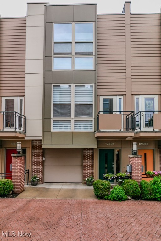 Beautifully updated 2-bed, 2.5-bath townhouse located in the heart of the vibrant Larchmere Art District, minutes from University Circle, Cleveland’s cultural hub. Enjoy an unbeatable location steps from Shaker Square, rapid transit access to downtown or the airport, and top institutions like Cleveland Clinic, University Hospitals, and Case Western Reserve University. This rare gem with original long term owner features a private courtyard and rooftop Trex deck with sweeping views of downtown—perfect for peaceful mornings/evening gatherings. Inside, you'll find nearly every detail thoughtfully updated. Entry level offers an attached 1-car garage with walk-in storage closet and bonus room with LVT flooring, heating/cooling, and natural light—ideal as a 3rd bedroom, office, or fitness space. Up the newly stained wood staircase, the second floor features a light-filled open layout with high ceilings, updated fixtures, and beautiful hardwood floors. The spacious great room boasts a gas fireplace, floor to ceiling windows, balcony access, and seamless flow into the updated kitchen with granite counters, solid wood cabinetry, peninsula seating, gas cooktop, and all appliances stay — including new '23 refrigerator. A stylish updated half bath and ample storage round out this level. Upstairs, brand new carpet leads to two generously sized bedrooms, each with floor to ceiling windows and their own full bathroom. Primary suite offers a walk-in closet, and stunning bathroom with a '24 marble shower floor, marble vanity, tile surround, and linen closet. Convenient hall laundry closet with stackable washer/dryer. Don’t miss the private rooftop deck, recently stained/sealed, a quiet escape with stunning skyline views. Additional Updates: Low emissivity windows to keep out the heat, Brand new AC June '25 & furnace (end of '24), Hot water tank & Interior paint ('18). Rare opportunity to own a move-in-ready townhome in one of Cleveland’s most artistic and accessible neighborhoods.